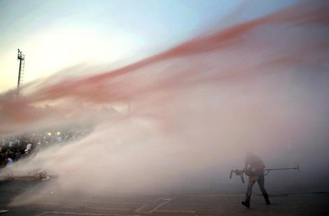 Protesters are attacked by police water cannon at the entrance Gezi Park near Istanbul's Taksim square June 15, 2013. REUTERS/Yannis Behraki Protesters are attacked by police water cannon at the entrance Gezi Park near Istanbul's Taksim square June 15, 2013. REUTERS/Yannis Behraki
