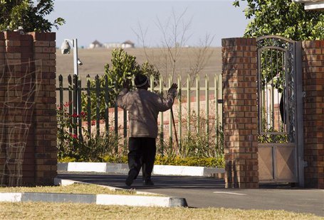 A village elder greets security personnel as he enters the home of former South African President Nelson Mandela, in Qunu June 25, 2013. REU A village elder greets security personnel as he enters the home of former South African President Nelson Mandela, in Qunu June 25, 2013. REU