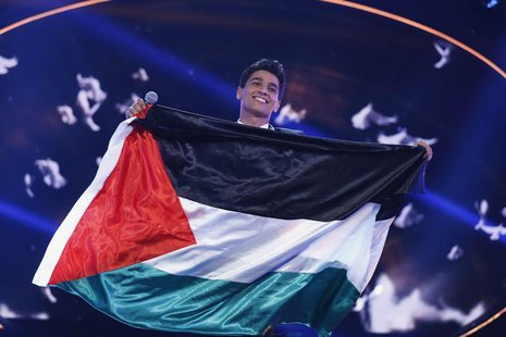 Palestinian singer Mohammed Assaf holds the Palestinian flag, as he stands on stage after being announced winner during the Season 2 finale Palestinian singer Mohammed Assaf holds the Palestinian flag, as he stands on stage after being announced winner during the Season 2 finale