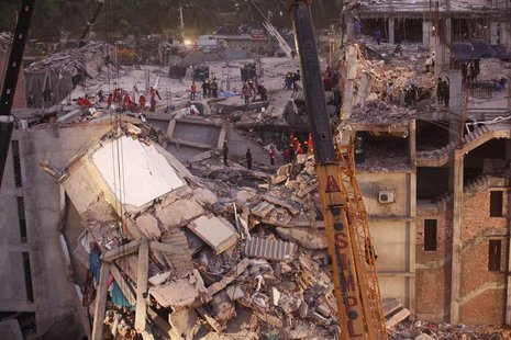 Rescue workers attempt to rescue garment workers from the rubble of the collapsed Rana Plaza building, in Savar, 30 km (19 miles) outside Dh Rescue workers attempt to rescue garment workers from the rubble of the collapsed Rana Plaza building, in Savar, 30 km (19 miles) outside Dh