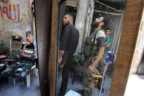 Free Syrian Army fighters carrying their weapons are reflected in a mirror in the old city of Aleppo June 24, 2013. REUTERS/Muzaffar Salman Free Syrian Army fighters carrying their weapons are reflected in a mirror in the old city of Aleppo June 24, 2013. REUTERS/Muzaffar Salman