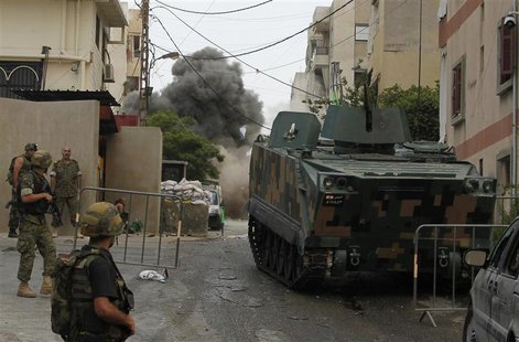 Smoke rises after Lebanese army soldiers detonated an explosive device, near the mosque complex where hardline Sunni cleric Sheikh Ahmed al- Smoke rises after Lebanese army soldiers detonated an explosive device, near the mosque complex where hardline Sunni cleric Sheikh Ahmed al-