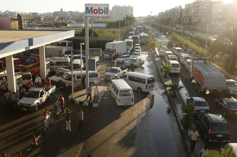 Drivers wait alongside their vehicles in long queues at a gas station during a fuel shortage in the country, in Alexandria June 24, 2013. RE Drivers wait alongside their vehicles in long queues at a gas station during a fuel shortage in the country, in Alexandria June 24, 2013. RE