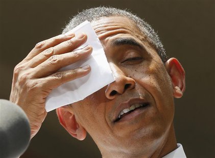 U.S. President Barack Obama pauses and wipes his forehead as he speaks about his vision to reduce carbon pollution while preparing the count U.S. President Barack Obama pauses and wipes his forehead as he speaks about his vision to reduce carbon pollution while preparing the count