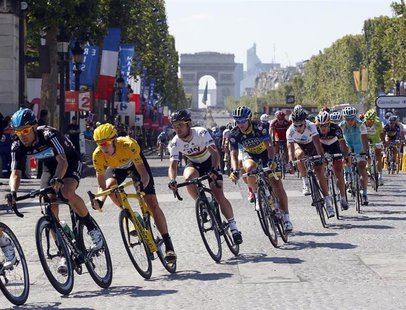 Sky Procycling rider and leader's yellow jersey Bradley Wiggins of Britain (2ndL) cycles on the Champs Elysees during the final 20th stage o Sky Procycling rider and leader's yellow jersey Bradley Wiggins of Britain (2ndL) cycles on the Champs Elysees during the final 20th stage o