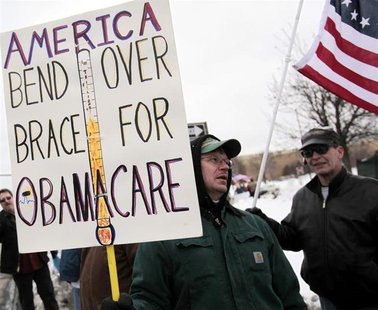 A Tea Party member carries a sign voicing his concern over "ObamaCare" during a rally marking the one-year anniversary of the movement in Tr A Tea Party member carries a sign voicing his concern over "ObamaCare" during a rally marking the one-year anniversary of the movement in Tr