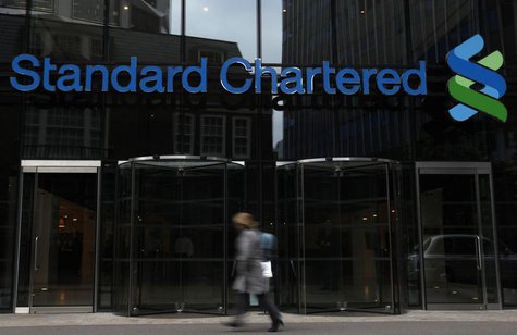 A woman walks past a Standard Chartered bank in London October 13, 2010. REUTERS/Stefan Wermuth A woman walks past a Standard Chartered bank in London October 13, 2010. REUTERS/Stefan Wermuth