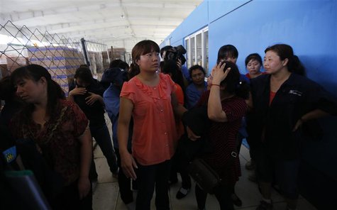 Factory workers stand in a factory where Chip Starnes, president of Florida-based Speciality Medical Supplies, is being held captive on the Factory workers stand in a factory where Chip Starnes, president of Florida-based Speciality Medical Supplies, is being held captive on the