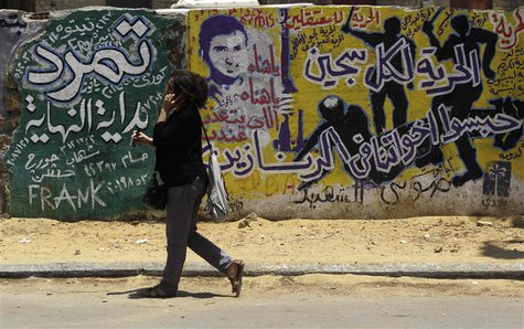 A woman walks past graffiti depicting riot police near Tahrir Square in Cairo June 23, 2013. REUTERS/Amr Abdallah Dalsh A woman walks past graffiti depicting riot police near Tahrir Square in Cairo June 23, 2013. REUTERS/Amr Abdallah Dalsh