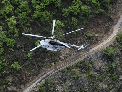 An Indian Air Force (IAF) helicopter, part of a rescue operation, flies over the Gauchar area after heavy rains in the Himalayan state of Ut An Indian Air Force (IAF) helicopter, part of a rescue operation, flies over the Gauchar area after heavy rains in the Himalayan state of Ut