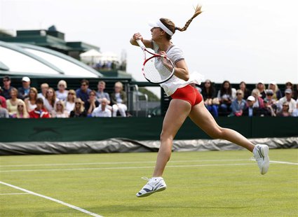 Alize Cornet of France hits a return to Hsieh Su-Wei of Taiwan in their women's singles tennis match at the Wimbledon Tennis Championships, Alize Cornet of France hits a return to Hsieh Su-Wei of Taiwan in their women's singles tennis match at the Wimbledon Tennis Championships,