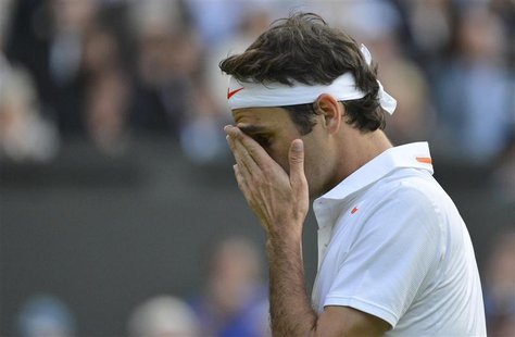 Roger Federer of Switzerland reacts during his men's singles tennis match against Sergiy Stakhovsky of Ukraine at the Wimbledon Tennis Champ Roger Federer of Switzerland reacts during his men's singles tennis match against Sergiy Stakhovsky of Ukraine at the Wimbledon Tennis Champ