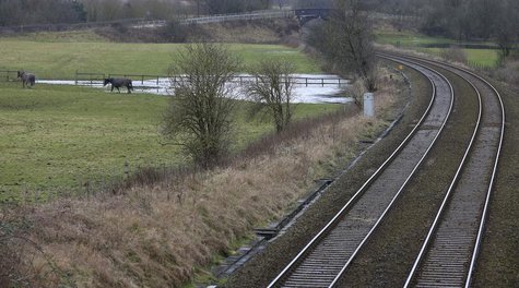 Existing rail tracks carve through fields near to the planned location of the new HS2 high speed rail link as it passes by the village of As Existing rail tracks carve through fields near to the planned location of the new HS2 high speed rail link as it passes by the village of As