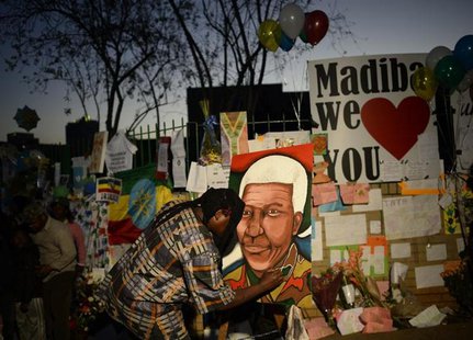A man paints a portrait of ailing former South African President Nelson Mandela outside the Medi-Clinic Heart Hospital where he is being tre A man paints a portrait of ailing former South African President Nelson Mandela outside the Medi-Clinic Heart Hospital where he is being tre