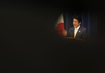 Japan's Prime Minister Shinzo Abe is seen through reporters as he speaks during a news conference at his official residence in Tokyo June 26 Japan's Prime Minister Shinzo Abe is seen through reporters as he speaks during a news conference at his official residence in Tokyo June 26