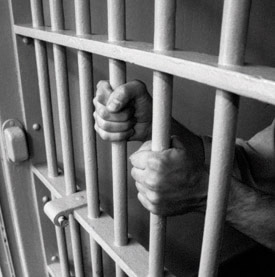 Inmate behind bars Inmate behind bars