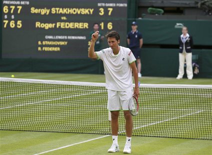 Sergiy Stakhovsky of Ukraine reacts after defeating Roger Federer of Switzerland in their men's singles tennis match at the Wimbledon Tennis Sergiy Stakhovsky of Ukraine reacts after defeating Roger Federer of Switzerland in their men's singles tennis match at the Wimbledon Tennis