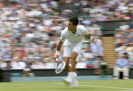 Novak Djokovic of Serbia hits a return to Florian Mayer of Germany in their men's singles tennis match at the Wimbledon Tennis Championships Novak Djokovic of Serbia hits a return to Florian Mayer of Germany in their men's singles tennis match at the Wimbledon Tennis Championships