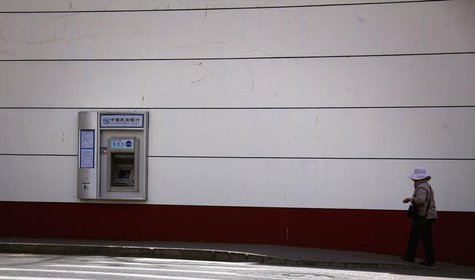 A woman walks along a footpath towards a China Minsheng Bank automatic teller machine (ATM) in central Beijing March 30, 2012. REUTERS/David A woman walks along a footpath towards a China Minsheng Bank automatic teller machine (ATM) in central Beijing March 30, 2012. REUTERS/David