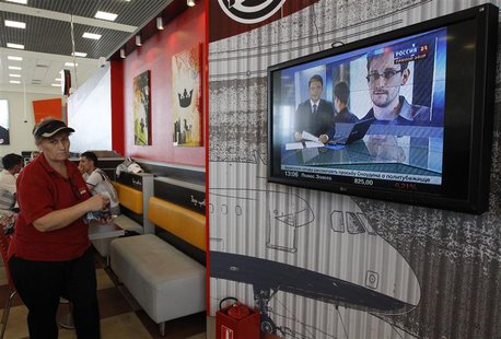 A television screens the image of former U.S. spy agency contractor Edward Snowden during a news bulletin at a cafe in Moscow's Sheremetyevo A television screens the image of former U.S. spy agency contractor Edward Snowden during a news bulletin at a cafe in Moscow's Sheremetyevo