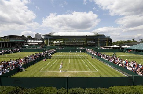 Jarkko Nieminen of Finland serves to Michael Llodra of France in their men's singles tennis match at the Wimbledon Tennis Championships, in Jarkko Nieminen of Finland serves to Michael Llodra of France in their men's singles tennis match at the Wimbledon Tennis Championships, in