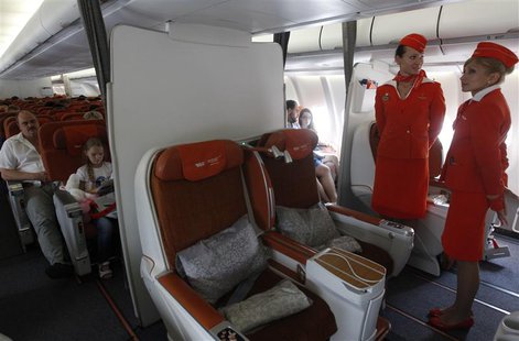 People sit onboard an Aeroflot Airbus A330 heading to the Cuban capital Havana at Moscow's Sheremetyevo airport June 27, 2013. REUTERS/Maxim People sit onboard an Aeroflot Airbus A330 heading to the Cuban capital Havana at Moscow's Sheremetyevo airport June 27, 2013. REUTERS/Maxim