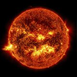 The bright light of a solar flare on the left side of the sun and an eruption of solar material shooting through the sun’s atmosphere, calle The bright light of a solar flare on the left side of the sun and an eruption of solar material shooting through the sun’s atmosphere, calle