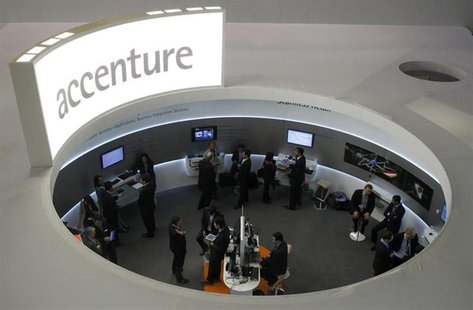 Visitors look at devices at Accenture stand at the Mobile World Congress in Barcelona, February 26, 2013. REUTERS/Albert Gea Visitors look at devices at Accenture stand at the Mobile World Congress in Barcelona, February 26, 2013. REUTERS/Albert Gea