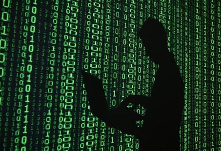 An illustration picture shows a projection of binary code around the shadow of a man holding a laptop computer in an office in Warsaw June 2 An illustration picture shows a projection of binary code around the shadow of a man holding a laptop computer in an office in Warsaw June 2