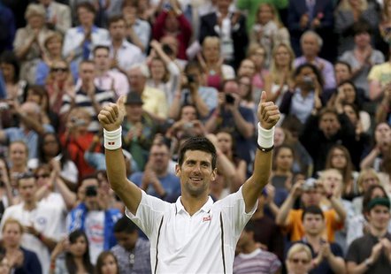Novak Djokovic of Serbia celebrates after defeating Bobby Reynolds of the U.S. during their men's singles tennis match at the Wimbledon Tenn Novak Djokovic of Serbia celebrates after defeating Bobby Reynolds of the U.S. during their men's singles tennis match at the Wimbledon Tenn