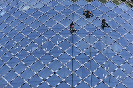 Workers clean windows of an office building in Tokyo's business district February 20, 2013. REUTERS/Toru Hanai Workers clean windows of an office building in Tokyo's business district February 20, 2013. REUTERS/Toru Hanai