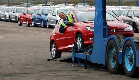 A worker loads a car onto a transporter at the PSA Peugeot Citroen Ryton plant in Coventry, central England, April 18, 2006. REUTERS/Darren A worker loads a car onto a transporter at the PSA Peugeot Citroen Ryton plant in Coventry, central England, April 18, 2006. REUTERS/Darren