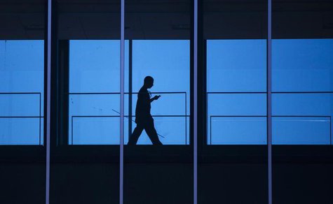 A student uses his mobile phone as he walks inside the Engineering building at the University of Waterloo, located beside the Blackberry mak A student uses his mobile phone as he walks inside the Engineering building at the University of Waterloo, located beside the Blackberry mak