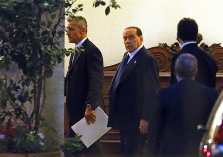 Italy's former Prime Minister Silvio Berlusconi (C) leaves his residence at Grazioli palace, downtown Rome June 25, 2013. REUTERS/Tony Genti Italy's former Prime Minister Silvio Berlusconi (C) leaves his residence at Grazioli palace, downtown Rome June 25, 2013. REUTERS/Tony Genti