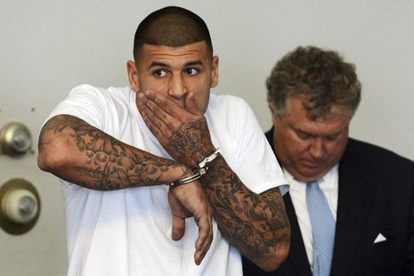 New England Patriots tight end Aaron Hernandez is arraigned on charges of murder and weapons violations in Attleborough, Massachusetts, afte New England Patriots tight end Aaron Hernandez is arraigned on charges of murder and weapons violations in Attleborough, Massachusetts, afte