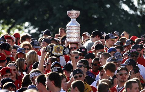 Chicago Blackhawks fans wait holding a replica of the Stanley Cup trophy before entering Hutchinson Field in Grant Park in Chicago, Illinois Chicago Blackhawks fans wait holding a replica of the Stanley Cup trophy before entering Hutchinson Field in Grant Park in Chicago, Illinois