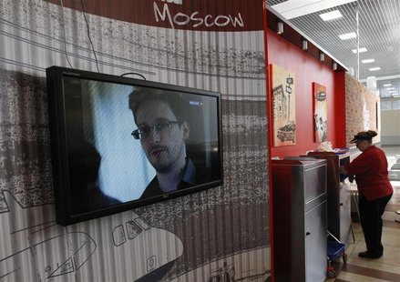 A television screens the image of former U.S. spy agency contractor Edward Snowden during a news bulletin at a cafe at Moscow's Sheremetyevo A television screens the image of former U.S. spy agency contractor Edward Snowden during a news bulletin at a cafe at Moscow's Sheremetyevo