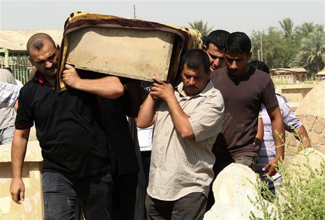 Relatives carry the coffin of a victim killed in one of two bomb attacks in Baquba, about 50 km (31miles) northeast of Baghdad, during a fun Relatives carry the coffin of a victim killed in one of two bomb attacks in Baquba, about 50 km (31miles) northeast of Baghdad, during a fun