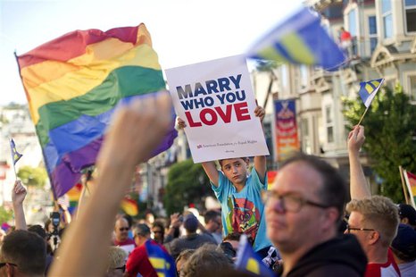 Enzo Catalano, 9, holds up a sign amongst thousands of revelers at Castro St. in San Francisco, California after the United States Supreme C Enzo Catalano, 9, holds up a sign amongst thousands of revelers at Castro St. in San Francisco, California after the United States Supreme C