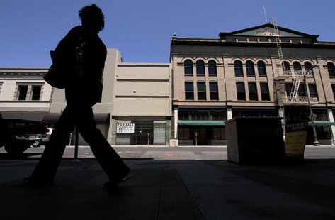 A woman walks past shuttered businesses in Stockton, California June 27, 2012. REUTERS/Kevin Bartram A woman walks past shuttered businesses in Stockton, California June 27, 2012. REUTERS/Kevin Bartram