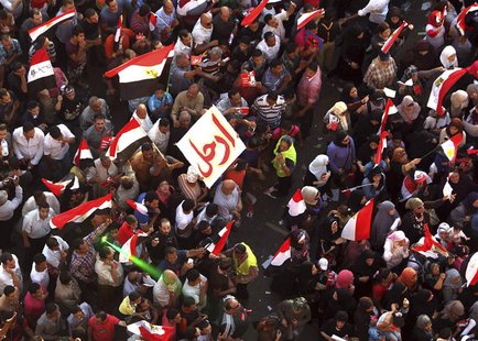 Protesters, with flags and a banner reading "Leave", chant anti-President Mohamed Mursi slogans during a protest in Tahrir square in Cairo J Protesters, with flags and a banner reading "Leave", chant anti-President Mohamed Mursi slogans during a protest in Tahrir square in Cairo J