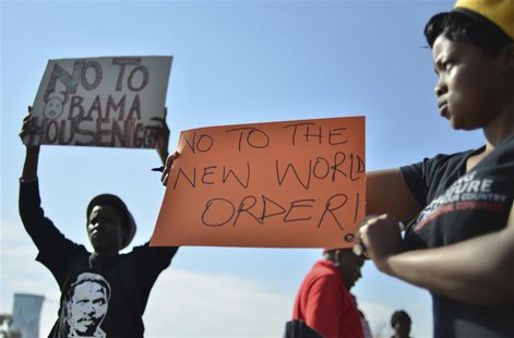 Protesters hold placards outside the University of Johannesburg in Soweto, ahead of a visit by U.S. President Barack Obama, June 29, 2013. R Protesters hold placards outside the University of Johannesburg in Soweto, ahead of a visit by U.S. President Barack Obama, June 29, 2013. R