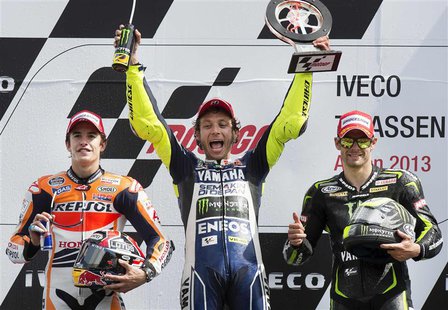 Yamaha MotoGP riders Cal Crutchlow of Britain and Valentino Rossi of Italy (C), and Honda MotoGP rider Marc Marquez of Spain (L) celebrate o Yamaha MotoGP riders Cal Crutchlow of Britain and Valentino Rossi of Italy (C), and Honda MotoGP rider Marc Marquez of Spain (L) celebrate o