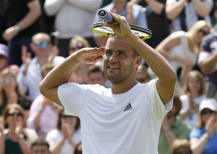 Mikhail Youzhny of Russia celebrates after defeating Viktor Troicki of Serbia in their men's singles tennis match at the Wimbledon Tennis Ch Mikhail Youzhny of Russia celebrates after defeating Viktor Troicki of Serbia in their men's singles tennis match at the Wimbledon Tennis Ch