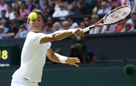 Bernard Tomic of Australia hits a return to Richard Gasquet of France during their men's singles tennis match at the Wimbledon Tennis Champi Bernard Tomic of Australia hits a return to Richard Gasquet of France during their men's singles tennis match at the Wimbledon Tennis Champi