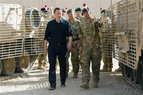 Britain's Prime Minister David Cameron (L) is given a tour of some of the heavy equipment used in operations, during his visit to Camp Basti Britain's Prime Minister David Cameron (L) is given a tour of some of the heavy equipment used in operations, during his visit to Camp Basti