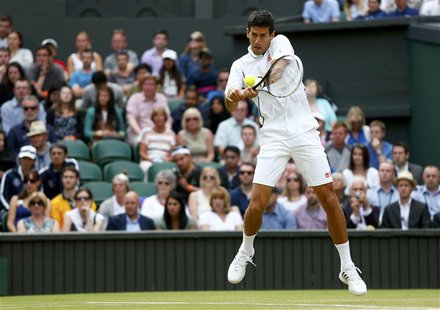 Novak Djokovic of Serbia hits a return to Jeremy Chardy of France in their men's singles tennis match at the Wimbledon Tennis Championships, Novak Djokovic of Serbia hits a return to Jeremy Chardy of France in their men's singles tennis match at the Wimbledon Tennis Championships,