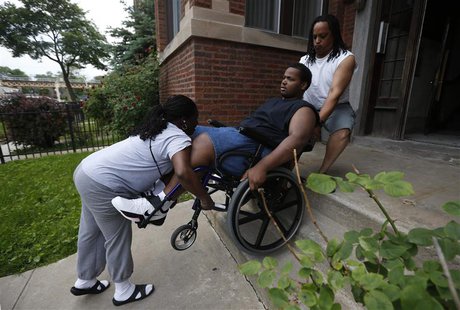 Miles Turner is helped up the stairs to his home by his mother Angela and his father Miles in Chicago, Illinois, June 9, 2013. REUTERS/Jim Y Miles Turner is helped up the stairs to his home by his mother Angela and his father Miles in Chicago, Illinois, June 9, 2013. REUTERS/Jim Y