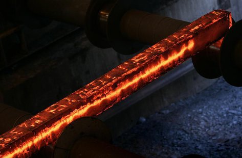 A hot steel bar is processed at the factory of Swiss Steel AG which is partly owned by the 'Schmolz + Bickenbach' group in Emmenbruecke, out A hot steel bar is processed at the factory of Swiss Steel AG which is partly owned by the 'Schmolz + Bickenbach' group in Emmenbruecke, out