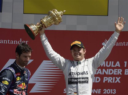 Mercedes Formula One driver Nico Rosberg (R) of Germany celebrates after winning the British Grand Prix as second placed Red Bull driver Mar Mercedes Formula One driver Nico Rosberg (R) of Germany celebrates after winning the British Grand Prix as second placed Red Bull driver Mar